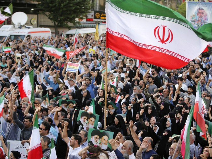 Crowds holding Iranian flags gather in the Revolution Square in the capital Tehran to protest the US attacks on three nuclear facilities in Iran on June 22, 2025